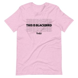 A pink This Is Blackbird Tee with the phrase "this is blackbird" repeated four times.